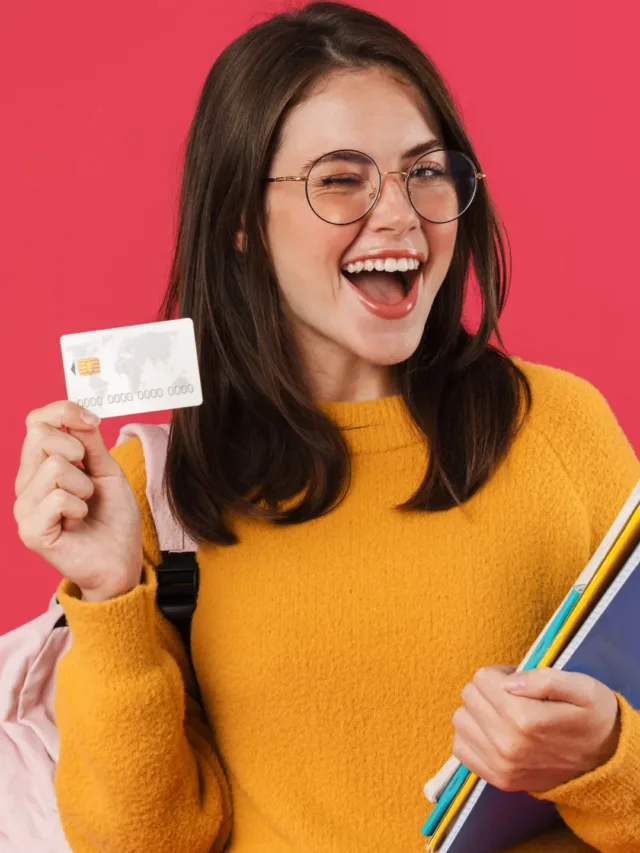 a female student wearing yellow top and holding credit card in her hand